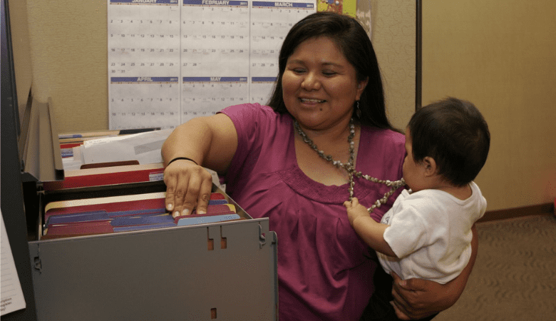woman filing with baby in workplace